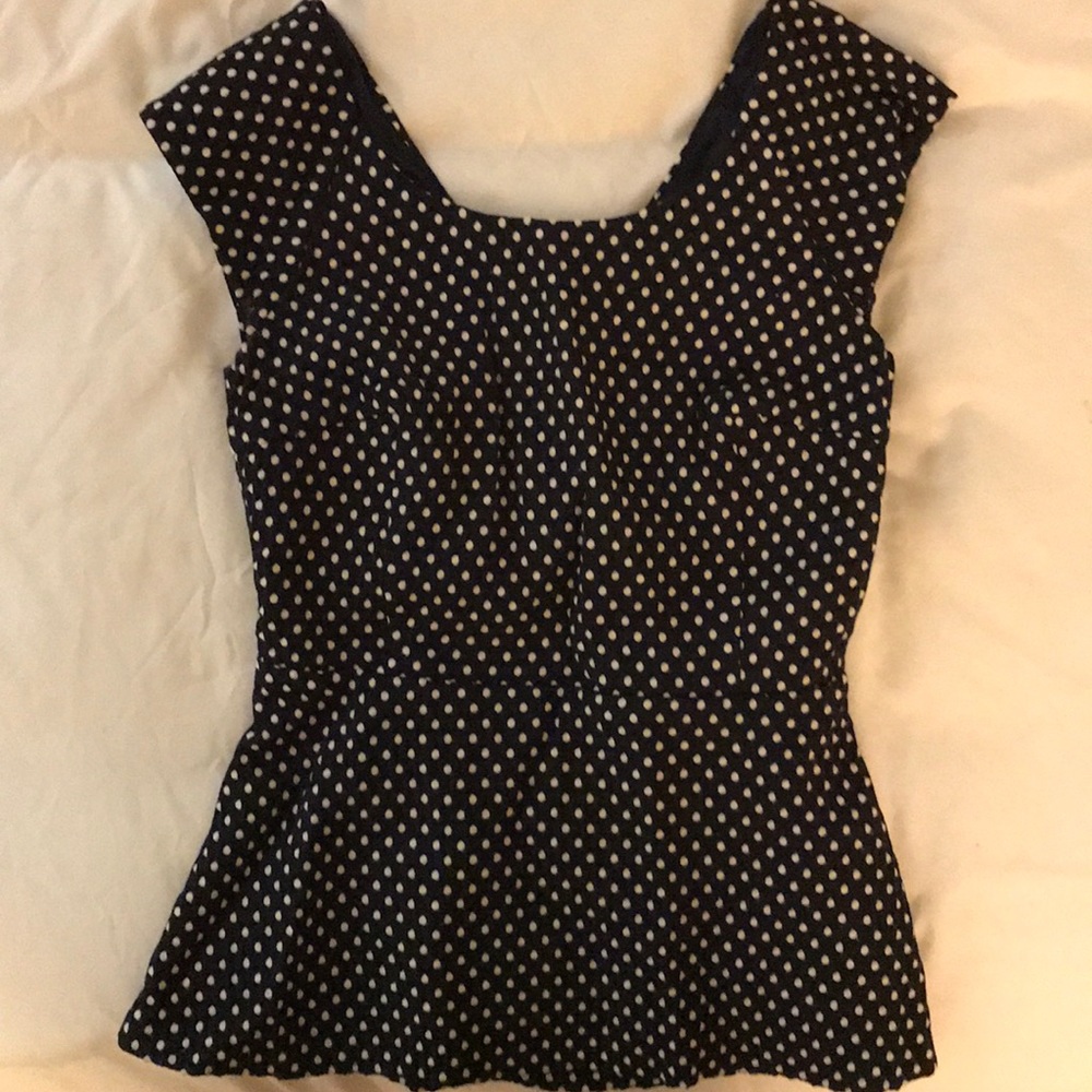 Cute peplum top with cutout in the back!